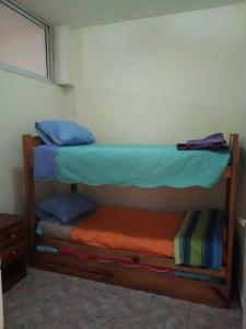 two bunk beds in a room with blue pillows at Departamento 4 ambientes para 5 personas 1 cama doble y una cucheta de 3 in Mar del Plata