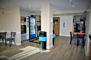 a room with a bar with chairs and a vending machine at Super 8 by Wyndham Clearfield in Clearfield