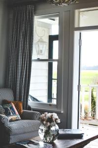 a living room with a couch and a window at Te Kopura Lodge in Martinborough 