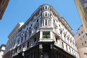 a tall building with a flower pot in a window at Hotel Le Petit in Rome