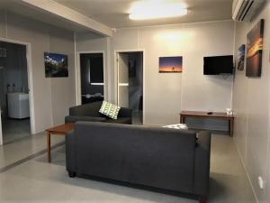 a living room with a couch and a table at Lake Callide Retreat in Biloela