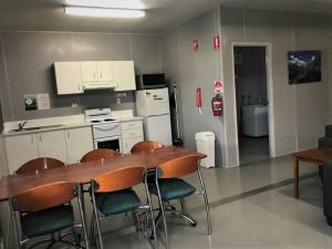 a kitchen with a table and chairs in a room at Lake Callide Retreat in Biloela
