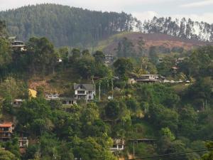 a village on a hill with houses and trees at Rawana Rock Road Homestay in Ella