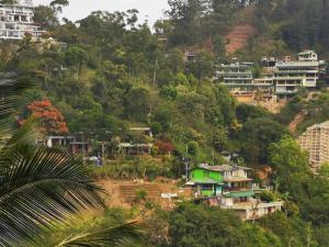 a village on the side of a hill with houses at Rawana Rock Road Homestay in Ella