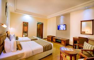 Postel nebo postele na pokoji v ubytování Hamdan Plaza Hotel Salalah, an HTG Hotel