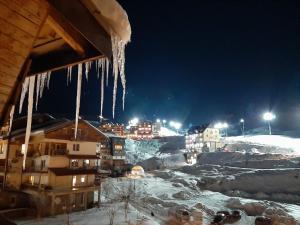 a group of icicles hanging from a building at night at Gudauri Ski Studio in Gudauri