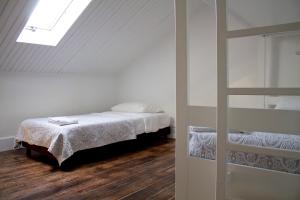a bedroom with a bed and a ladder at WW Hostel & Suites in Coimbra