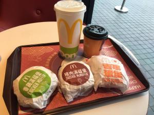 a tray with two sandwiches and a cup of coffee at Apple Tree Bed and Breakfast in Hualien City