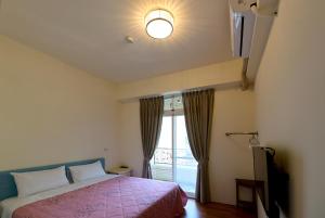 Postel nebo postele na pokoji v ubytování Light Time Homestay + 8 fotografií