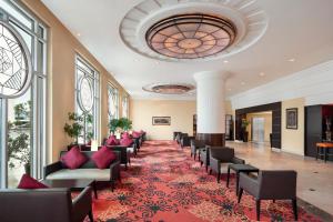 a living room filled with furniture and a large clock at Ramada Plaza by Wyndham Dubai Deira in Dubai