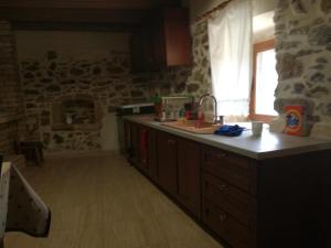 a kitchen with a counter and a sink and a window at The Rock in Kapetanianá