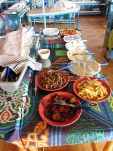 a table with plates of food on top of it at Bet El Kerem Guesthouse in Aswan