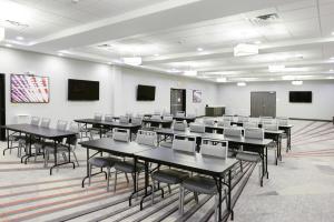 a classroom with tables and chairs in a room at Holiday Inn Abilene - North College Area by IHG in Abilene
