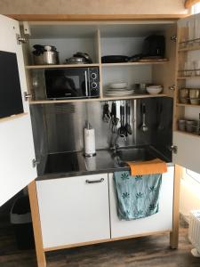 a kitchen with a sink and a microwave at FeWo Time Out 2 in Vreden