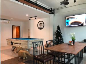 a living room with a pool table and a dining area at Richmond Nan Hotel in Nan