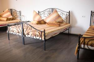 a metal bench with pillows on it in a room at Motel Aris Meridian in Piatra Neamţ