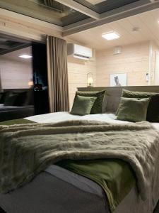 a large bed with a blanket on it in a room at Arctic Skylight Lodge in Äkäslompolo