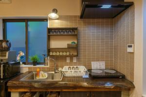 a kitchen with a sink and a counter at YADOYA Ueno-Rikyu in Tokyo