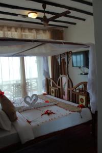 Postel nebo postele na pokoji v ubytování Royal Cliff Zanzibar