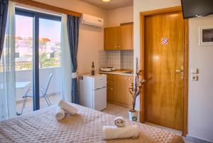 a bedroom with a bed with towels on it at Davinci's Studios in Haraki