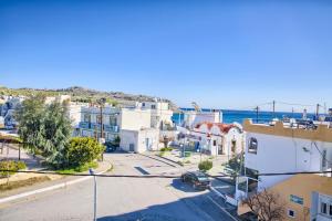 an aerial view of a small town with the ocean at Davinci's Studios in Haraki