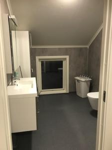 a bathroom with a sink and a toilet at Kjelkebakken gård 2. in Lyngseidet