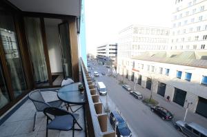 a balcony with a table and chairs and a city street at 2 · High-Quality in the heart of Stuttgart 2 in Stuttgart