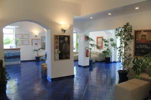 a lobby with a waiting area with plants in it at Hotel Residence La Darsena in Agropoli