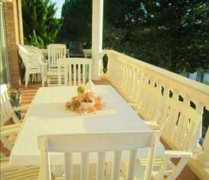 a white table and chairs on a deck at Villa Tito in Cunit