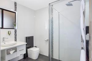 a bathroom with a shower, toilet and sink at Comfort Inn May Park in Horsham