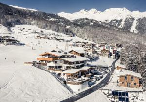 a ski resort in the snow with snow covered mountains at Leni Mountain Appartements in Sölden