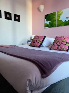 um quarto com uma cama grande e 2 almofadas em Hôtel La Rotonde em La Croix-Valmer