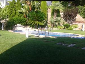 a playground in a yard with a swimming pool at Villa Tito in Cunit