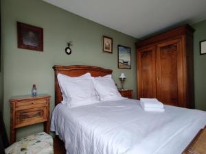 a bedroom with a large white bed with a wooden headboard at Paris On Top in Paris