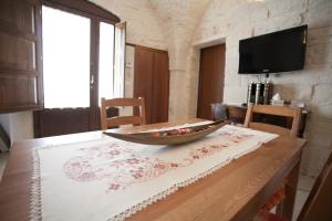a wooden table with a bowl on top of it at Trullo Dell’Antica Fileria in Alberobello