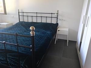 łóżko z niebieską kołdrą w sypialni w obiekcie Casa Zeralda, privater Pool w mieście Budoni