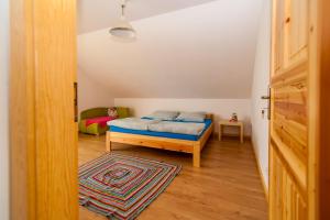 PrzykonaZagroda Olszówka的一间卧室配有一张床,铺有木地板。