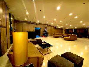 a living room with a christmas tree in the middle at Your HOME @ Princeton Residences, New Manila in Manila
