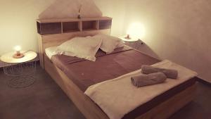 a bedroom with a large wooden bed with two tables at La Kaz Kian in Sainte-Rose