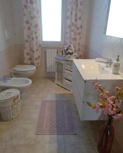 a bathroom with a sink and a toilet and a sink at B&b il Giardino da Pina in Tuili
