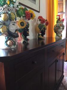 a wooden cabinet with vases on top of it at B&B Il Padrino in Savoca