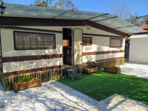 an rv parked in a driveway with a green lawn at For Nature Lovers 2 in Skala Rachoniou