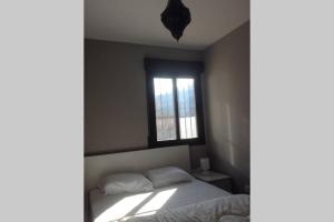 a bedroom with a bed and a window at Sierra Nevada Luxury Getaway in Güéjar-Sierra