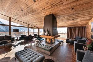 a living room filled with furniture and a fireplace at Skilodge Oberlech in Lech am Arlberg
