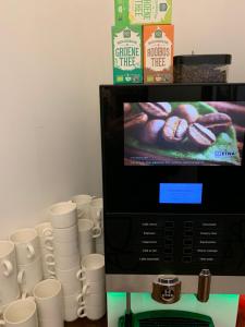 a pile of coffee cups sitting next to a microwave at Hotel Oorsprongpark in Utrecht