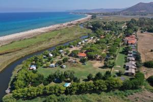 an aerial view of a group of houses on the shore of a river at Camping Ermosa in Posada