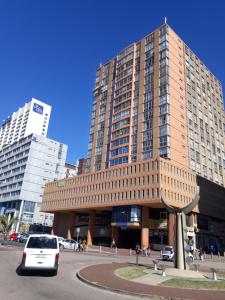a car parked in front of a large building at Into The Blue on the Beach in Durban