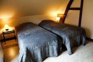 En eller flere senge i et værelse på Gîte rural Les petites têtes