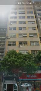 a tall building with a tree in front of it at Loft Copacabana in Rio de Janeiro +32 photos