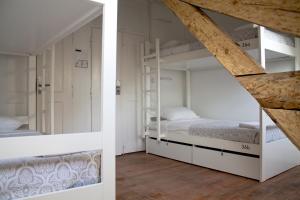 a bedroom with two bunk beds and a staircase at WW Hostel & Suites in Coimbra